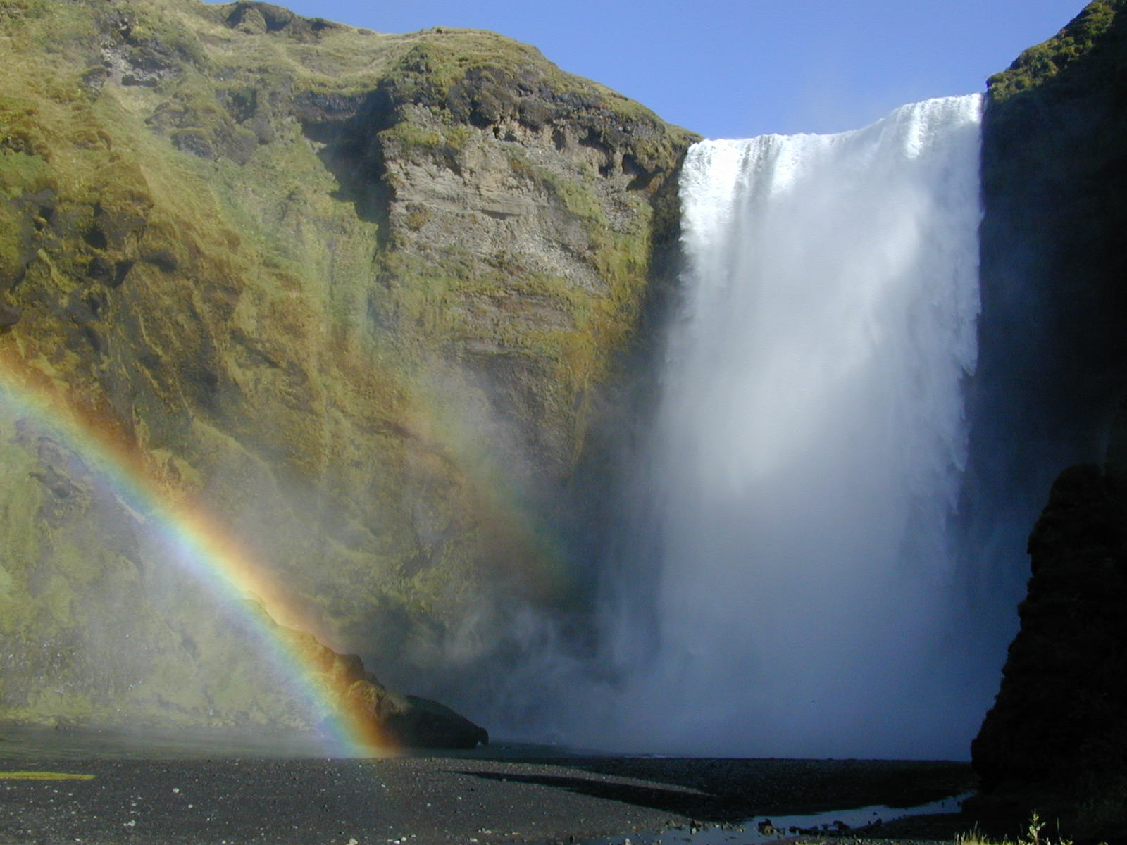 Skógafoss waterfall with a rainbow in Iceland